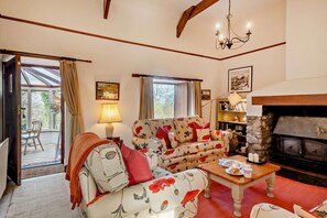 A cozy living room with a sofa set, a fireplace, and a bookshelf. - 4 Bed in Wooler (oc-196438) (Akeld)