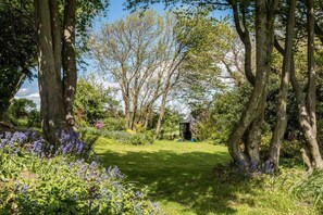 A garden with trees, a grassy path, and a gazebo. - 4 Bed in Wooler (oc-196438) (Akeld)