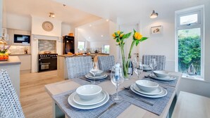 A modern kitchen with a dining area. - 3 Bed in Trevone (oc-p00758) (Trevone)