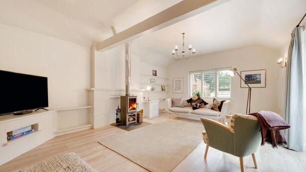 A spacious living room with a fireplace, a sofa, a television, and a dining area. - 2 Bed in Middleton (oc-rfb) (Middleton Moor)