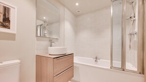 A modern bathroom with a white vanity, a bathtub, and a glass shower enclosure. - 2 Bed in Middleton (oc-rfb) (Middleton Moor)