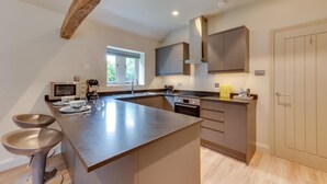 A modern kitchen with a large island, built-in appliances, and a window providing natural light. - 2 Bed in Middleton (oc-rfb) (Middleton Moor)