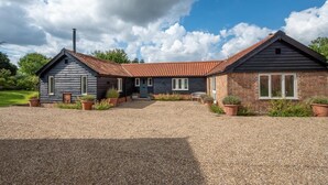 A two-story house with a gravel driveway and potted plants. - 2 Bed in Middleton (oc-rfb) (Middleton Moor)