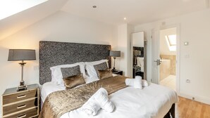 A modern hotel room with a large bed, two bedside tables, a headboard with a patterned design, and a skylight. - 3 Bed in Belford (oc-gd0144) (Adderstone with Lucker)