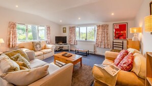 A cozy living room with two sofas, a coffee table, a TV, and a fireplace. - 1 Bed in Catton (oc-b31984) (Catton)