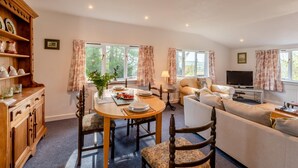 A cozy living room with a dining area, a sofa, a TV, and a bookshelf. - 1 Bed in Catton (oc-b31984) (Catton)