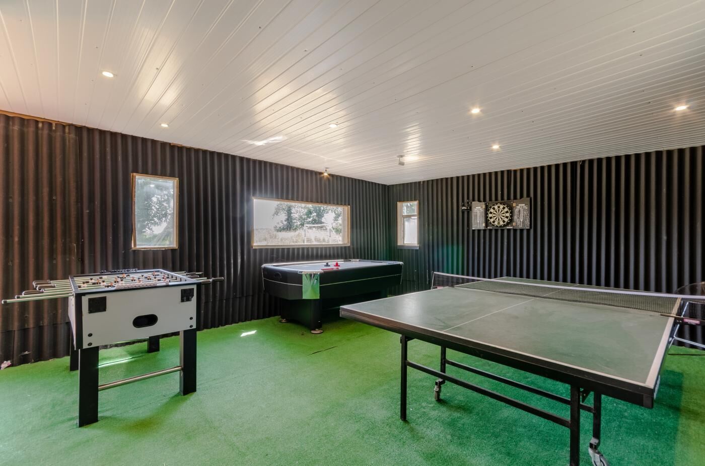 Ein Raum mit Kicker-, Billard- und Tischtennisplatten.