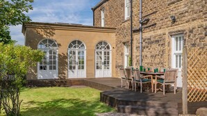 A stone building with a covered patio and a lawn. - 4 Bed in Beamish (oc-o32025) (Beamish)