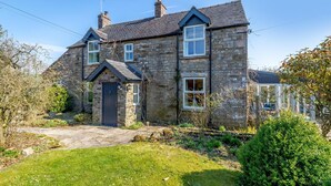 A stone house with a front door, a small porch, and a garden. - 4 Bed in Onecote (oc-b31731) (Onecote)