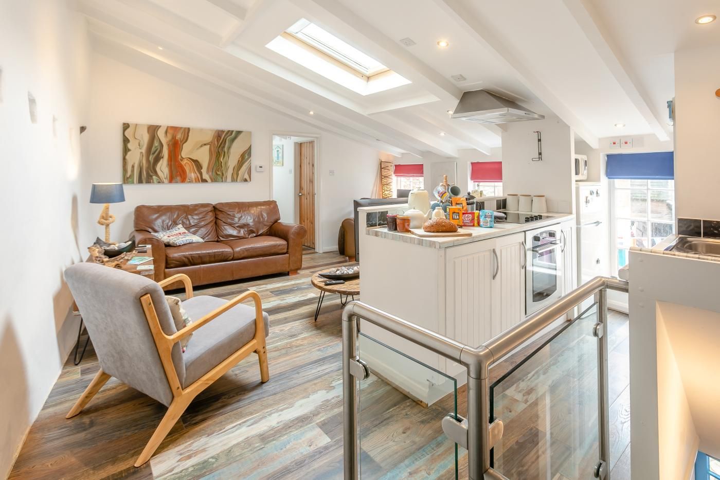 A modern interior with a living area, a kitchen, and a dining space.