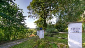 A farm gate with a sign reading "CRWCCA FARM" amidst lush greenery and trees. - 2 Bed in Felindre (oc-hh39) (Felindre)