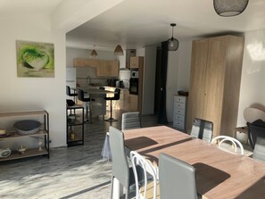 Una cocina moderna con armarios de madera, una isla central e iluminación colgante.