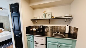 A compact kitchen with teal cabinets, a black countertop, and a white refrigerator. - Modern Retro #10, WiFi, A/C, walk to the Strip (Geneva)