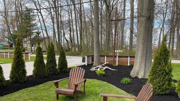 An outdoor seating area with two wooden Adirondack chairs, a metal fire pit, and a wooden bench. - Modern Retro #10, WiFi, A/C, walk to the Strip (Geneva)