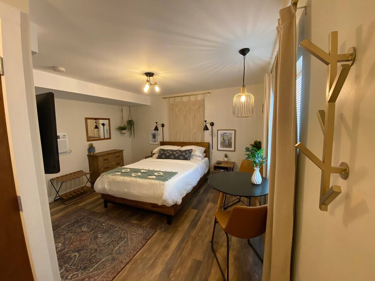 Ein Schlafzimmer mit einem Bett, Nachttischen, einem Schreibtisch und einem Stuhl.