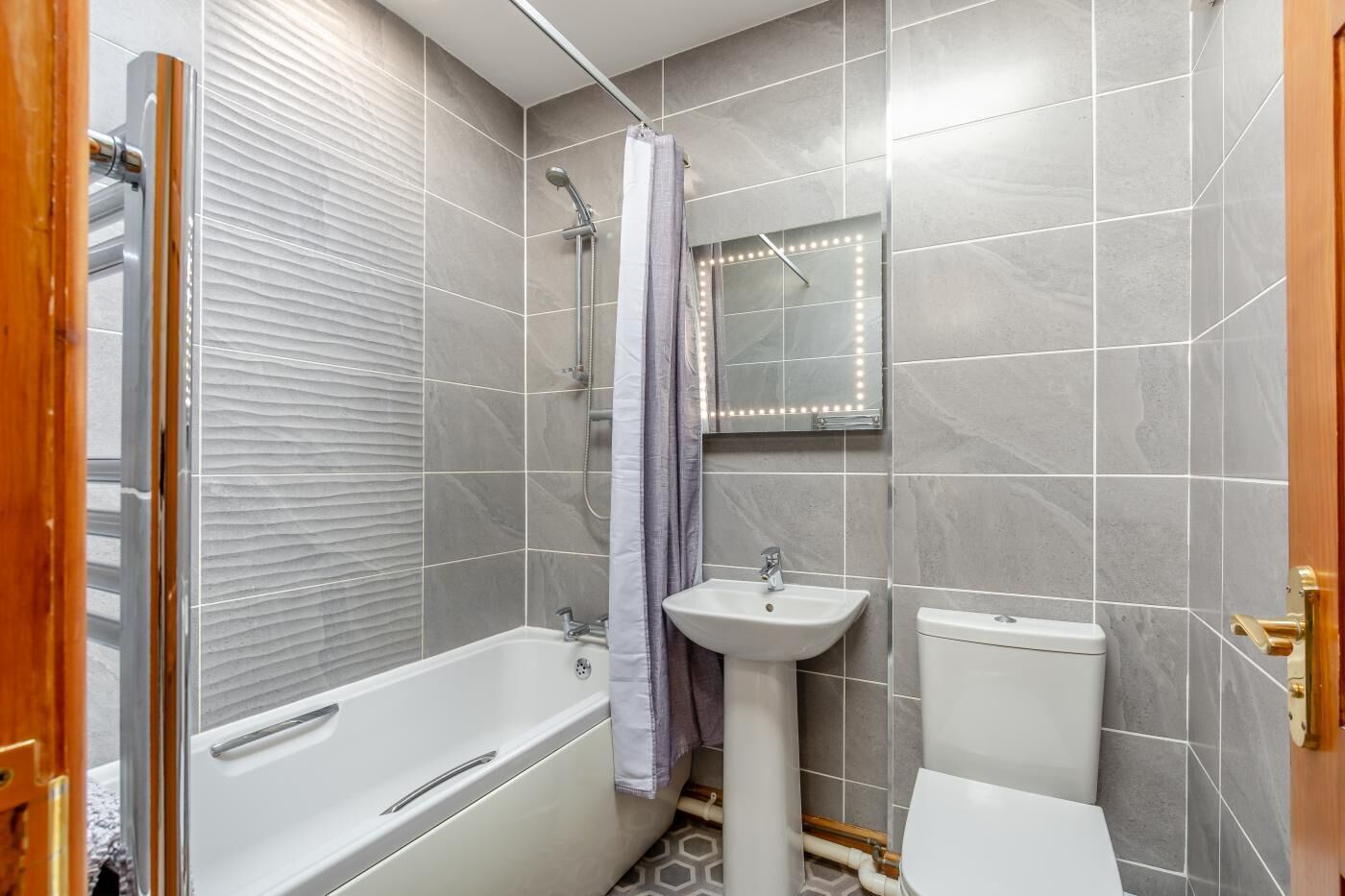 A bathroom with a bathtub, a sink, and a toilet.