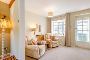 A cozy living room with two armchairs, a sofa, a lamp, a side table, and a window with curtains. - 2 Bed in Warton (oc-b31819) (Warton)