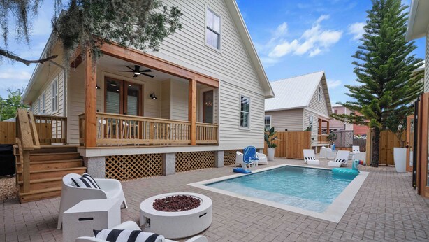 A house with a covered porch, a swimming pool, and outdoor seating. - The Augustine Suite l Heated Pool  l Walk to DNTN (St. Augustine)