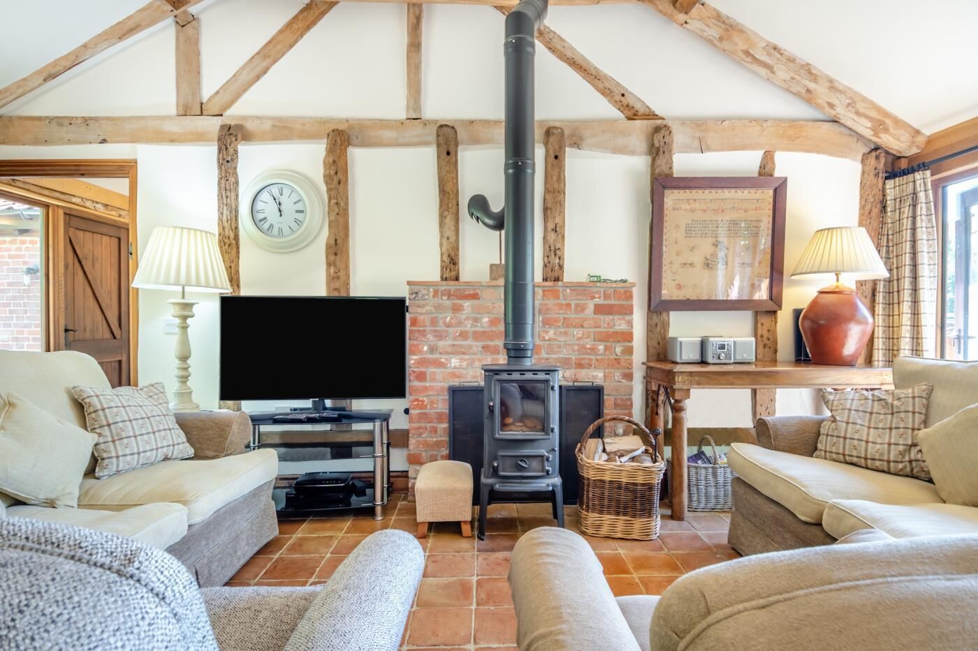 A cozy living room with a fireplace, a television, and comfortable seating.