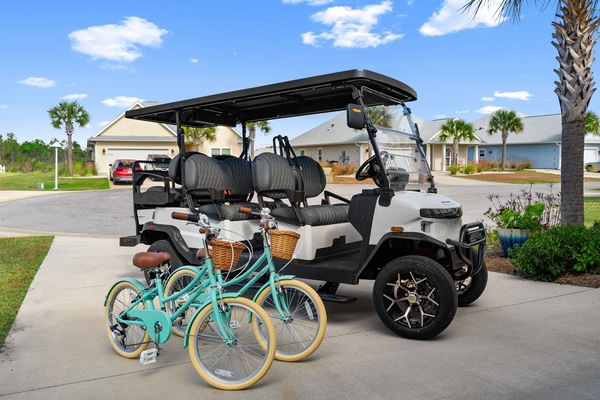 Golf cart and bikes await your neighborhood adventures under sunny Florida skies.