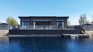 A modern house with a pool, featuring a large deck and a covered outdoor area. - 2 Bed in Tallington (oc-b32208) (Maxey)