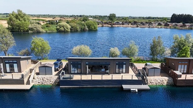 A waterfront property with modern cabins, a dock, and a view of the lake. - 2 Bed in Tallington (oc-b32208) (Maxey)
