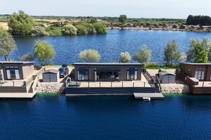 A waterfront property with modern cabins, a dock, and a view of the lake. - 2 Bed in Tallington (oc-b32208) (Maxey)