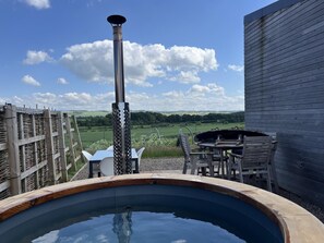 A hot tub with a wooden deck, a metal chimney, and a view of a grassy field. - 2 Bed in Kelso (oc-gd1860) (Kelso)