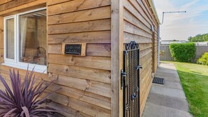 A wooden cabin with a sign reading "Limewood Annex," a window, and a gated entrance. - 1 Bed in Apley (oc-l32084) (Apley)