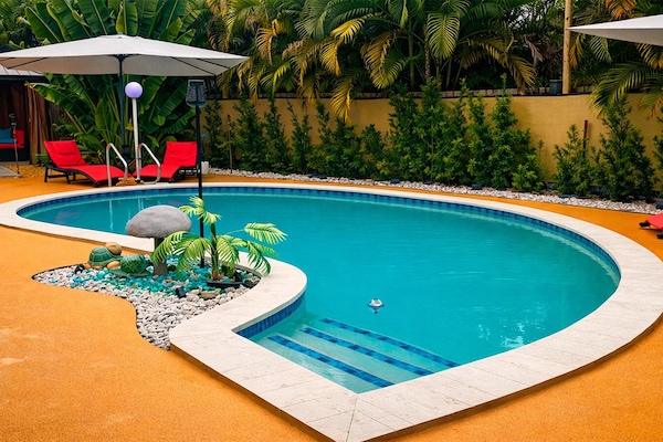Heated, clothing-optional, saltwather pool surrounded by lush tropical landscaping.
