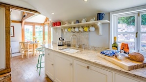 A kitchen with a large window, a sink, and a countertop with various items. - 3 Bed in Lower Holbrook (oc-2aglh) (Lower Holbrook)