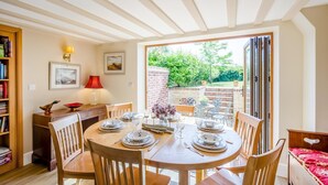 A dining area with a round table, chairs, a lamp, and a bookshelf. - 3 Bed in Lower Holbrook (oc-2aglh) (Lower Holbrook)