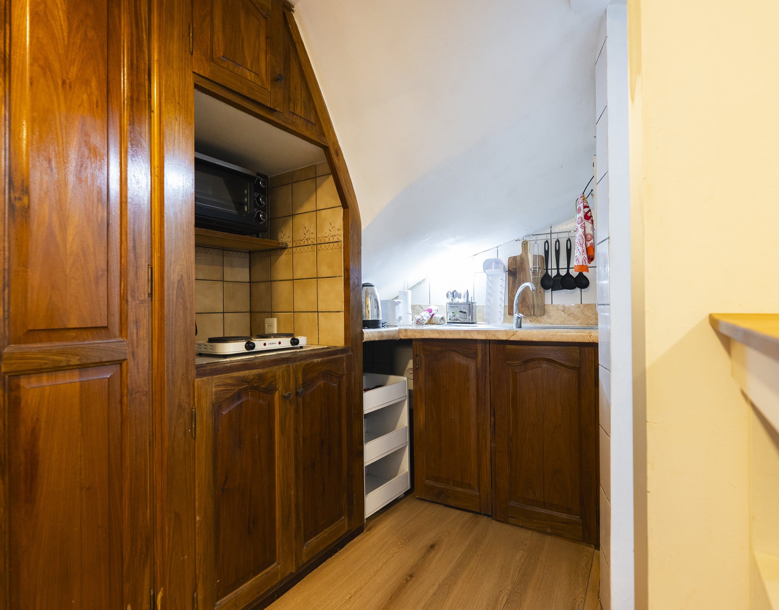 A kitchen with wooden cabinets, a microwave, and a stove.