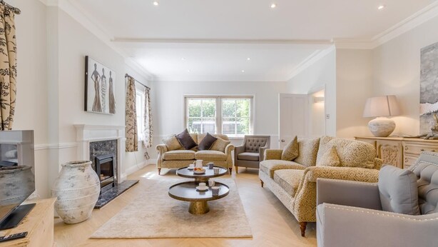 A spacious living room with a fireplace, two sofas, a coffee table, and a television. - 4 Bed in Holt (oc-a32207) (Holt)