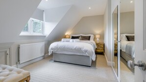 A bedroom with a sloped ceiling, a window, a radiator, a bedside table, and a bed. - 4 Bed in Holt (oc-a32207) (Holt)