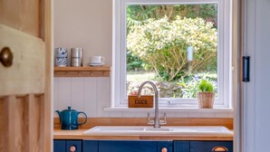 A kitchen with a window, a sink, a blue cabinet, a kettle, and a sign that reads "EGG'S". - 4 Bed in Ruswarp (oc-d32269) (Ruswarp)
