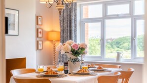 A breakfast setting with a table set for six, including croissants, juice, and a coffee pot. - 4 Bed in Ruswarp (oc-d32269) (Ruswarp)