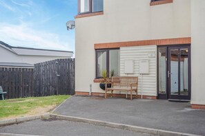 A residential building with a front porch, a bench, a potted plant, and a satellite dish. - 4 Bed in Amble (oc-gd1868) (Amble)