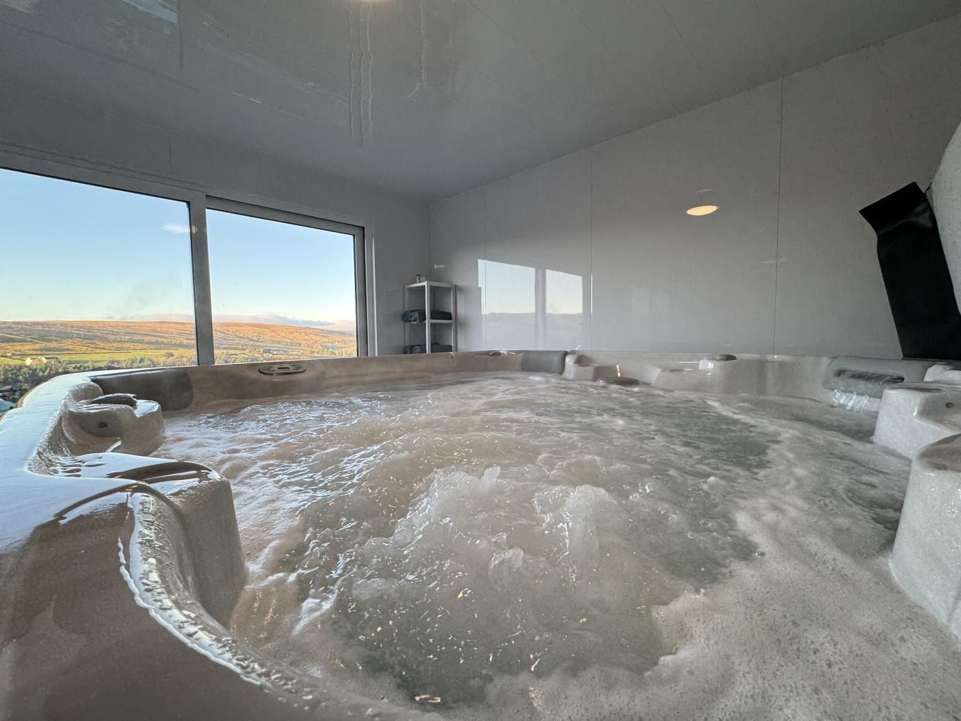 A hot tub with a panoramic view of a landscape.