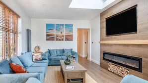 A modern living room with a sofa set, a coffee table, and a fireplace. - 4 Bed in Berrow (oc-h32250) (Berrow)