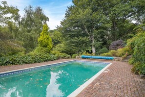 A rectangular swimming pool with a tiled edge, surrounded by a brick pathway and lush greenery. - 5 Bed in Battle (oc-l32238) (Battle)
