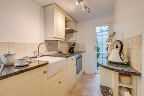 Een oven, een vaatwasser, kookgerei, borden en bestek