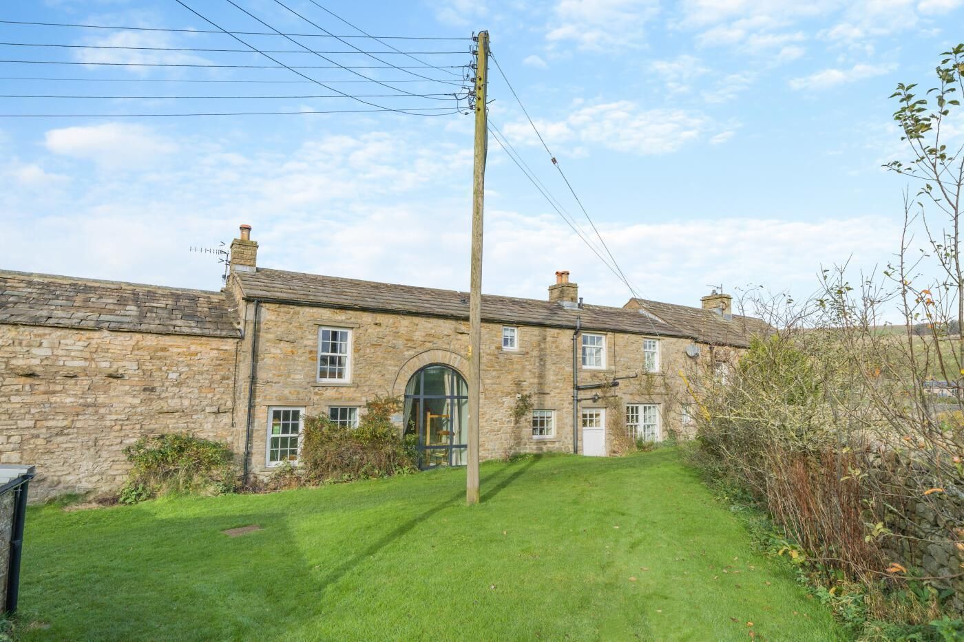 A stone building with a green lawn in front.