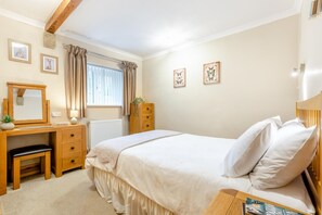 A bedroom with a bed, a desk, a chair, a dresser, a mirror, and a window with curtains. - 2 Bed in Cowling (oc-ds238) (Cowling)