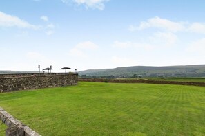 A grassy field with a stone wall and a gazebo. - 2 Bed in Cowling (oc-ds238) (Cowling)