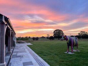 A colorful zebra statue in a grassy field with a building in the background. - 5 Bed in Wigglesworth (oc-w32112) (Wigglesworth)