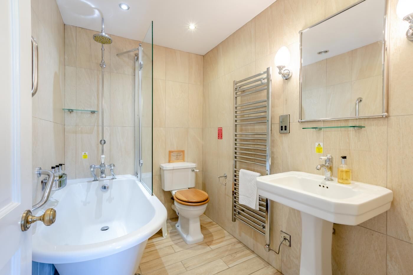 A modern bathroom with a bathtub, toilet, and sink.
