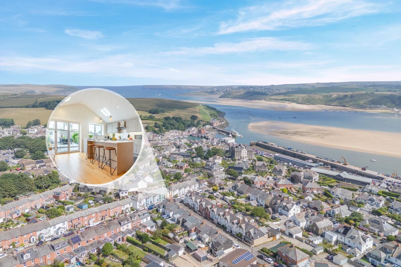 An aerial view of a coastal town with a prominent beach and a historic building.