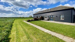 A dark-colored building with a paved driveway and a grassy lawn. - 2 Bed in Newton (oc-swro) (Newton)
