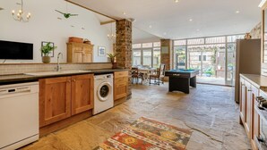 A spacious kitchen with a stone column, a pool table, and a dining area with natural light. - 4 Bed in Cawton (oc-t32408) (Cawton)